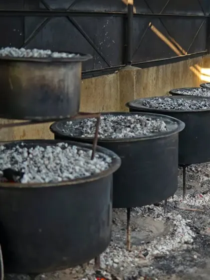 A line of biryani pots on 'dum'. This method of slow cooking with coals on top is what gives our biryani its signature flavour and perfect texture.