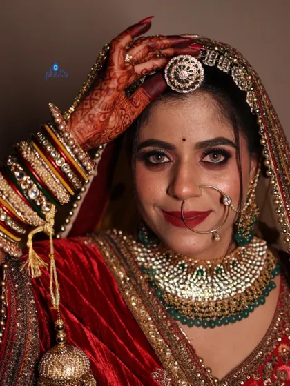 A happy and confident bridal portrait, capturing the bride's smile and the stunning details of her ring and headpiece.