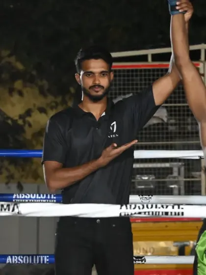 The referee raises our fighter's arm, declaring him the winner at the State Level Muay Thai Pro Championship.