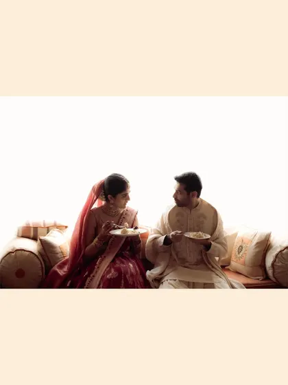 Even sharing a meal can be a beautiful, intimate moment on a wedding day. This wide shot captures the couple in a quiet, everyday act of love, a reminder that marriage is built on these simple, shared experiences.