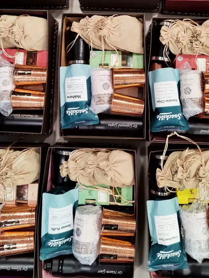 An overhead view of a corporate bulk order. Each hamper is consistently packed with care to ensure a uniform and high-quality gifting experience.