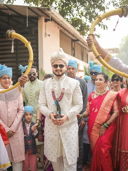 The groom's grand arrival, heralded by the sound of the shenai and tutari, surrounded by his happy family.
