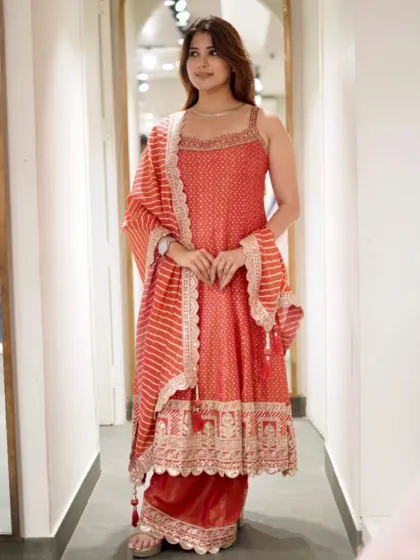 This outfit is a pure statement. A beautiful red printed suit with palazzo pants and a contrasting striped dupatta.