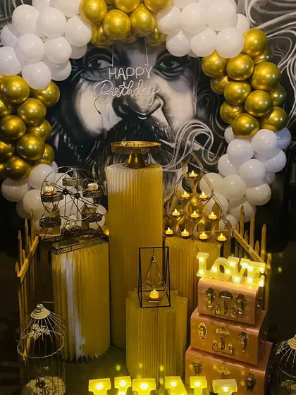 Another view of the stunning birthday setup in front of a wall mural, showing the arrangement of props and balloons.