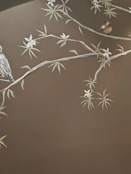 An owl and a small bird perched on delicate branches against a dark, moody background. This was part of a larger nature-themed mural for a child's room.