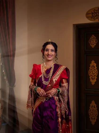 A portrait of the Marathi bride, bathed in the soft, natural light from a window, looking absolutely radiant.