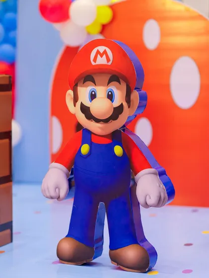 A life-sized Super Mario character prop stands ready to welcome guests. The high-quality cutout adds a professional and immersive touch to the video game-themed celebration.