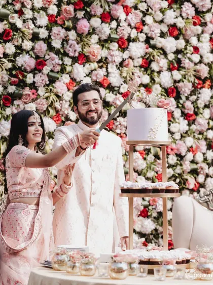 The cake cutting ceremony is a classic moment of celebration. I capture it against the stunning floral backdrop for a picture-perfect memory.