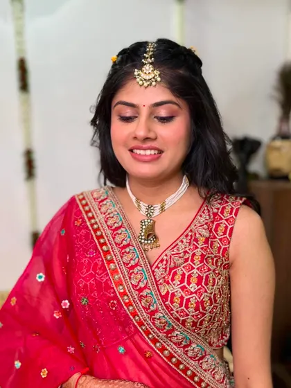 Another angle of this pretty-in-pink bridal look. The soft waves in her hair and the delicate makeup come together for a look that is both modern and traditional.