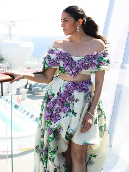The full look, showing how the floral gown stands out against the stunning backdrop of the sea. Location is always a key part of my styling story.