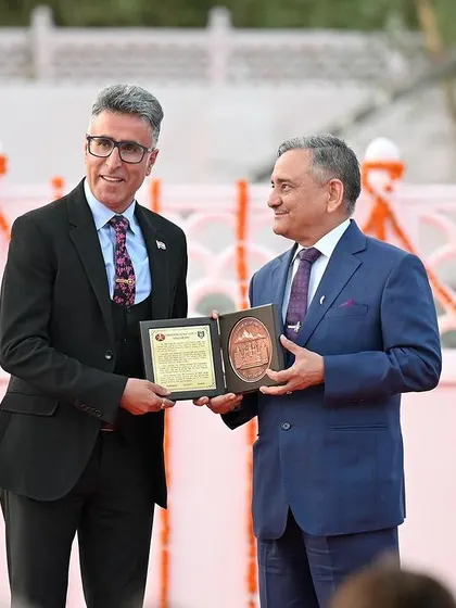 An award or memento being presented during the Kargil event. These are key moments that mark the significance of the occasion.