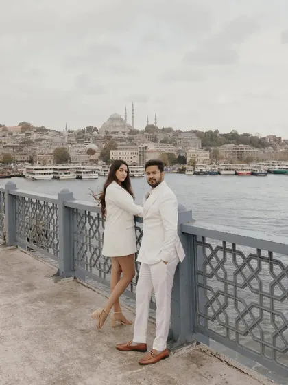 Sankriti and Rahul on a bridge in Istanbul, with the city's iconic skyline behind them. This pre-wedding shoot captured their adventurous spirit in a historic city.