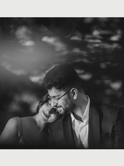 A timeless black and white photo of a couple sharing a quiet, tender moment. The soft lighting and focus on emotion make this a classic portrait from their mountain pre-wedding session.