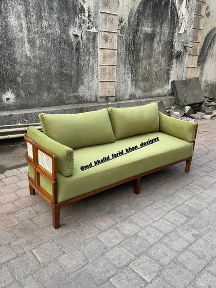 Front view of the green sofa, a statement piece that adds a pop of color and sophisticated design to any room.