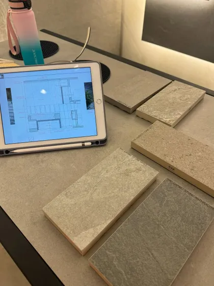 A snapshot of our work process, combining digital plans on an iPad with physical tile samples. This hybrid approach helps us and our clients make informed decisions.