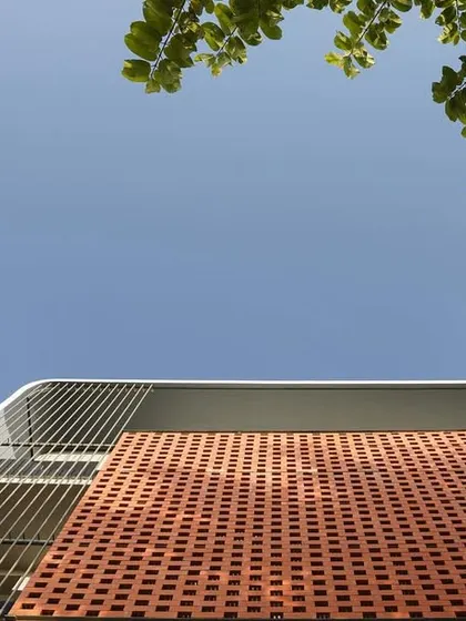 An upward-looking shot of the brick facade against the sky, highlighting the texture and pattern of the brickwork.