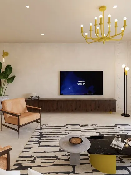 This view of the Jayanagar residence highlights the TV unit and an arched entryway leading to another part of the home. The pop of yellow from the chandelier adds a vibrant touch to the otherwise neutral and earthy color scheme.