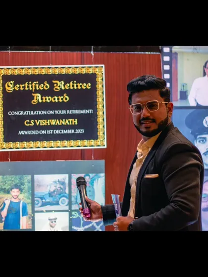Posing next to a collage celebrating the life and career of a retiree.