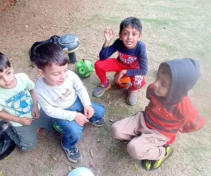 A candid moment of friendship and fun as a group of boys sits together after a football drill. Our classes are a great place for kids to socialize and make new friends.