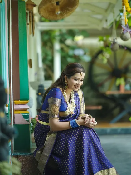 These photos capture a serene and elegant look, with the model wearing our Guttapusalu necklace set with a deep blue silk saree.