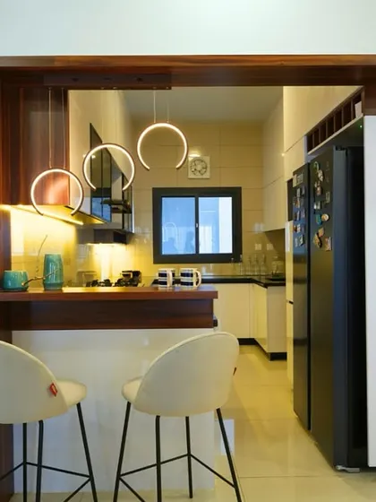Sometimes, all you need is a nice corner with warm lights for a cup of coffee. This kitchen pass-through counter with stylish bar stools and ring pendant lights does it all.