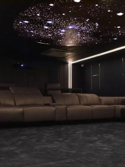 This is our reference home cinema demonstration room, complete with luxury seating and a fiber-optic starlit ceiling. A visit here will show you the pinnacle of private cinema design.
