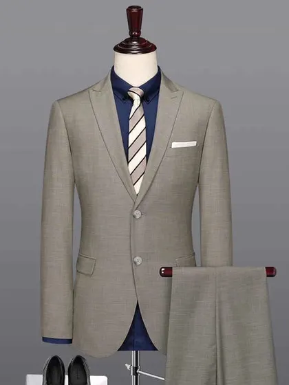 A grey two-piece suit paired with a navy blue shirt. This shows how you can style our classic suits for a modern, smart-casual look.