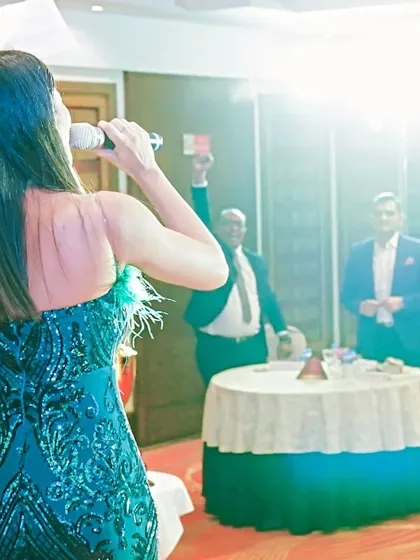 A view from the back of my green sequined gown while hosting. It's important to look great from every angle on stage.