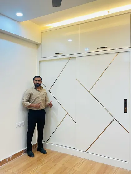 A finished sliding wardrobe with a white and gold geometric pattern. This design is perfect for adding a touch of glamour and modernity to a bedroom.