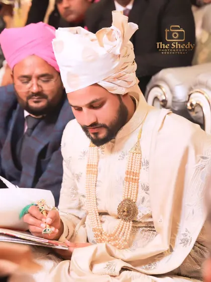 The solemn moment of the Nikah ceremony, as the groom signs the marriage contract. We respectfully capture the most important traditions of your wedding day.