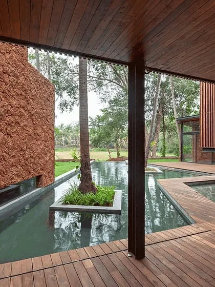 The interplay of wood, water, and stone in this villa courtyard. This image captures our love for creating serene, private oases that allow residents to slide into nature and enjoy a moment of calm.