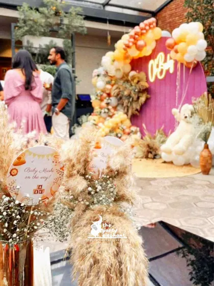 This shot shows the centerpiece in the context of the party, with the main baby shower backdrop visible in the background, demonstrating the cohesive design of the event.