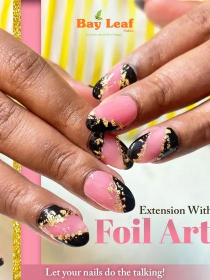 A bold and luxurious look featuring almond-shaped nail extensions with a modern pink and black design, highlighted by delicate gold foil art for a touch of glamour.