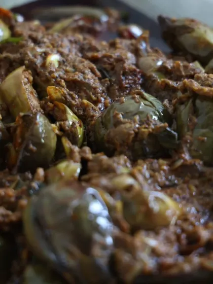 A close-up of our rich brinjal curry, showing the thick masala coating each piece.