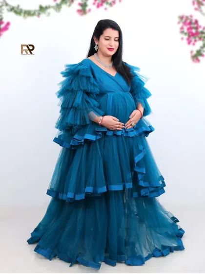 A solo portrait in a beautiful blue gown. The floral accents on the white background add a delicate and fresh touch to the image.