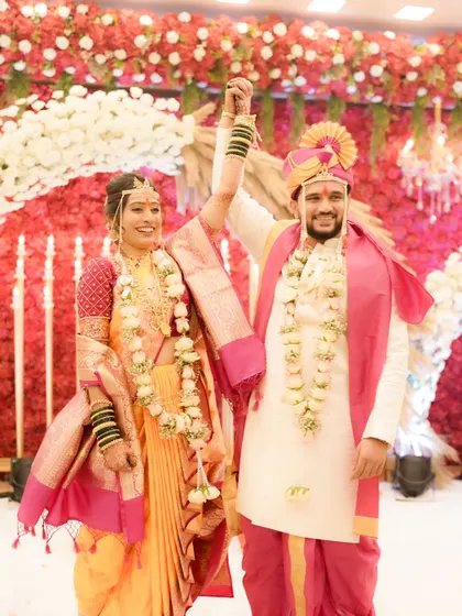 A moment of celebration. The bride's makeup remains flawless and radiant as she and her groom celebrate their union.