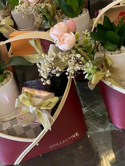 A closer view of our corporate Diwali hampers. You can see how the live plants and wine bottles are elegantly arranged with other goodies, creating a sophisticated and thoughtful gift.
