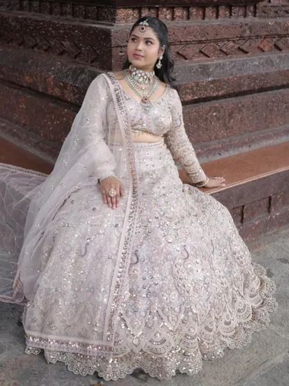 This seated pose highlights the beautiful flare of the lehenga skirt and its intricate embroidery.