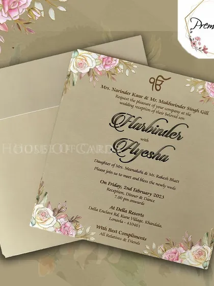 A beautiful Sikh wedding invitation with a soft beige background and a delicate pink floral border, perfect for a multi-faith celebration.