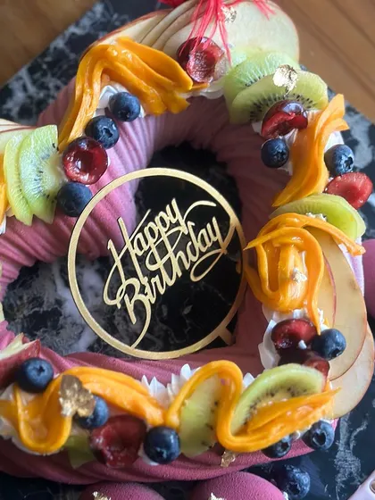 Indulge in elegance with our classy lavender cake, adorned with exotic fruits. This heart-shaped entremet cake is perfect as a centerpiece for a sophisticated dessert spread.