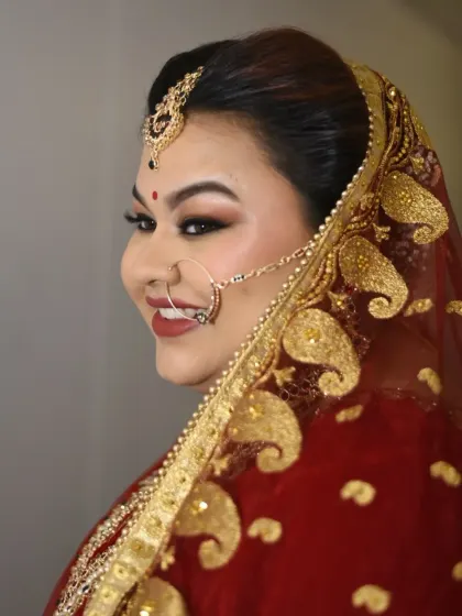 The perfect bridal portrait, capturing the essence of her soft glam makeup and the richness of her attire.