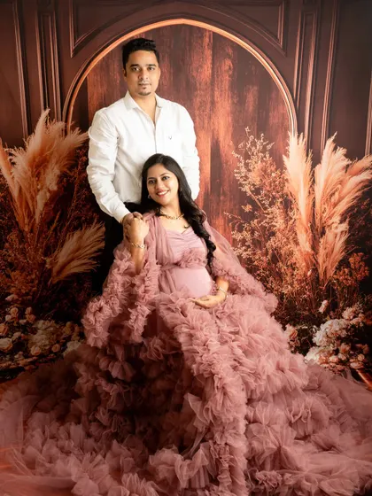 A formal couple's portrait with a beautiful ruffled gown. The pose is elegant and captures the couple as a strong, united team.