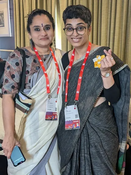 The power of a shared smile. I make it a point to connect with attendees one on one, fostering a warm and welcoming environment at every event.