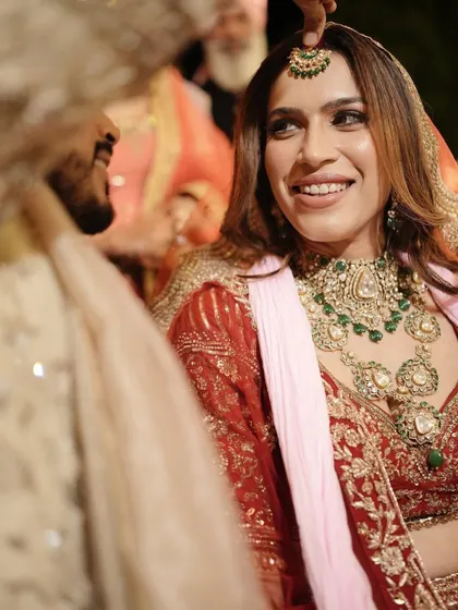 A close-up of the bride and groom. Her makeup is designed to look flawless both in person and in photos, enhancing her features without overpowering them.