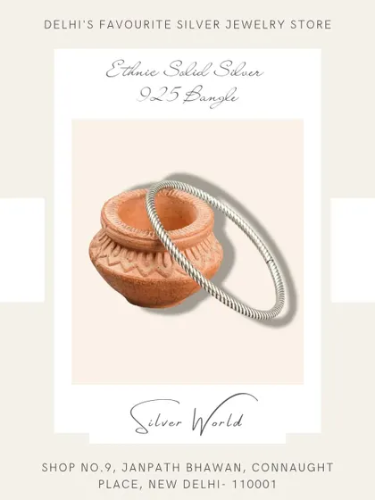 A sleek, twisted, or 'rope' style solid silver bangle. This is an ethnic design that is both simple and elegant.