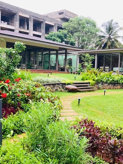 We used a variety of flowering plants and shrubs to add color and texture, creating a vibrant garden that contrasts beautifully with the green lawn and surrounding trees.