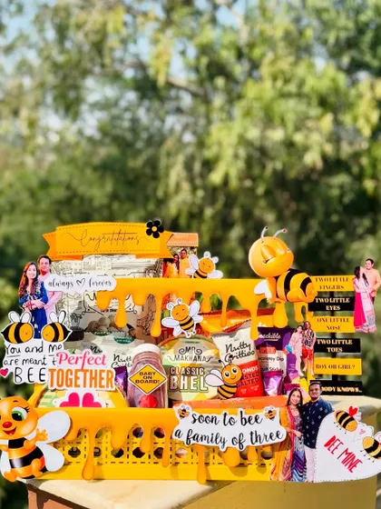 This "Soon to Bee a Family of Three" hamper is a sweet and punny gift for an anniversary or baby announcement. The honeybee theme is carried throughout, with cute decorations and a basket full of treats.