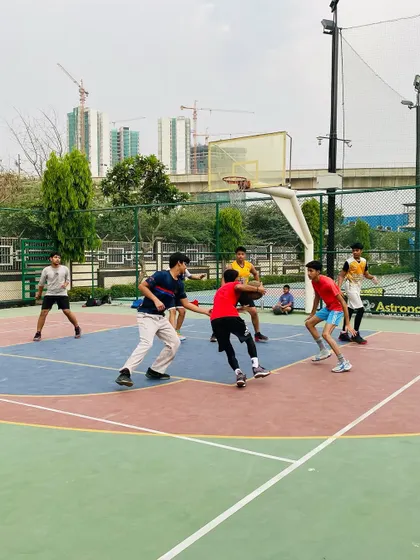 A player drives baseline against a defender, a classic offensive move we teach.
