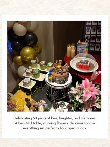 A beautifully styled dessert table celebrating 50 years of love, laughter, and memories, complete with a gorgeous cake, flowers, and a cheese board.
