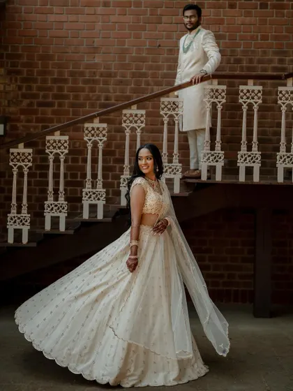 A stunning bride in a white lehenga, exuding grace and elegance. We use creative framing and lighting to capture a variety of beautiful portraits.